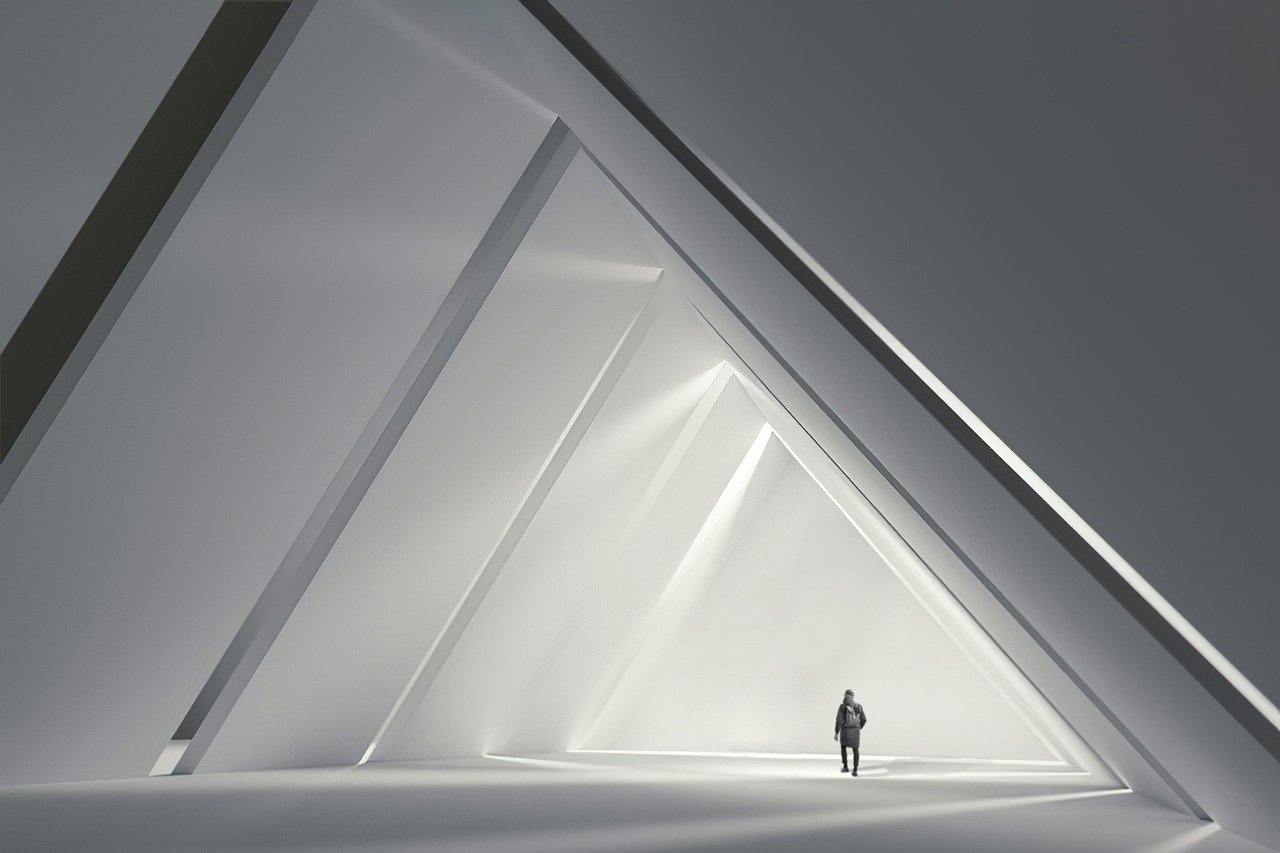 a person standing in a room with triangular windows